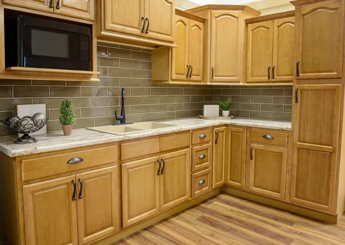 Honey oak kitchen cabinets with a tile backsplash