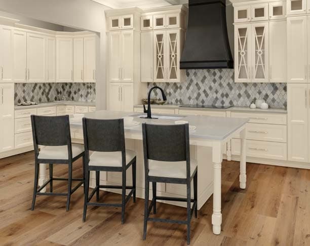 Linen-colored kitchen cabinets with an island and bar stools