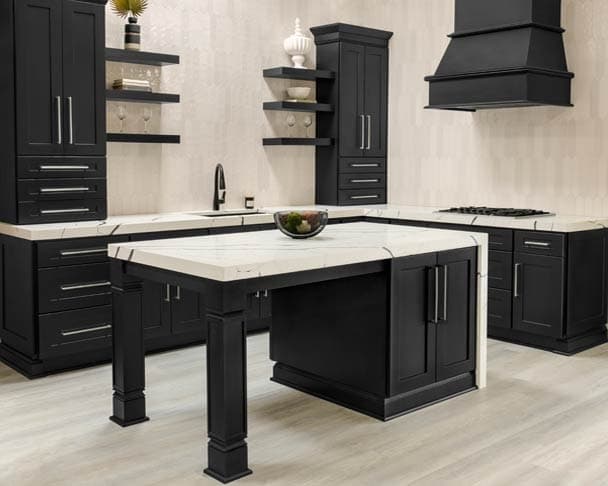 Black shaker kitchen cabinets with a matching island and wood hood
