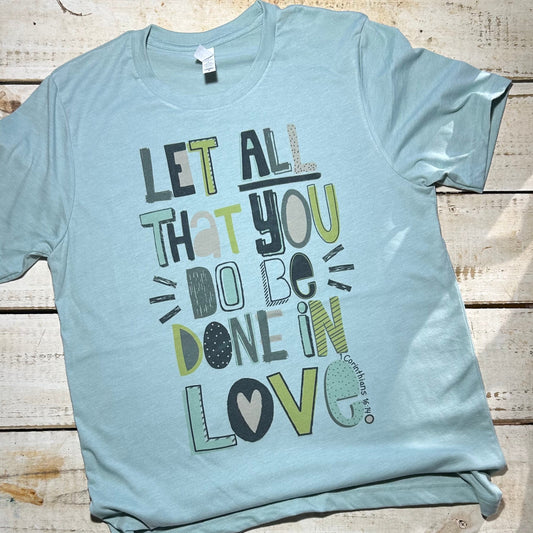 Alt Text: A Bella Canvas Dusty Blue shirt from the Red Oak Faith Collection featuring the quote "Let All That You Do Be Done in Love" in elegant typography and the Red Oak Faith logo. The unisex fit, soft fabric, and timeless design make it a versatile and comfortable choice for expressing faith and love in style.