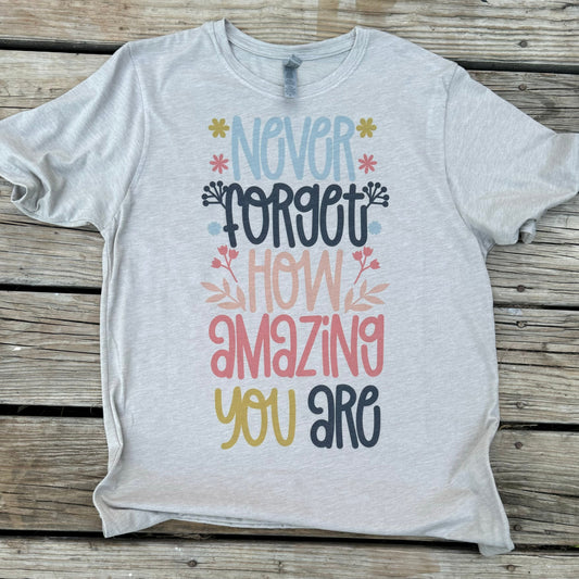 Stay motivated and inspired with the Never Forget How Amazing You Are T-shirt. Made with high-quality Next Level material in a sleek silver color, this shirt is perfect for teachers and anyone in need of a confidence boost. Remember, you are amazing!

Printed on a Next Level Silver&nbsp;