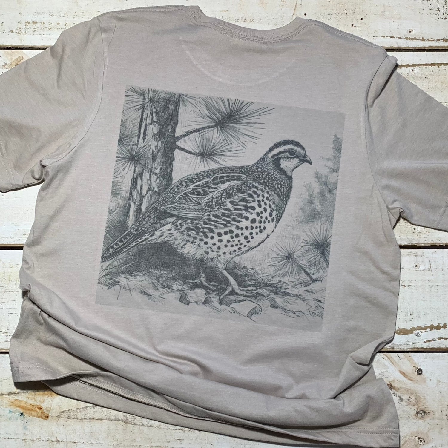 Stunning Red Oak Quail design on a Bella-Canvas heather tan t-shirt from the Backyard to Backwoods Apparel collection. Celebrate nature's beauty with this stylish and comfortable tee, perfect for outdoor enthusiasts and those who appreciate the charm of backyard wildlife.  Back