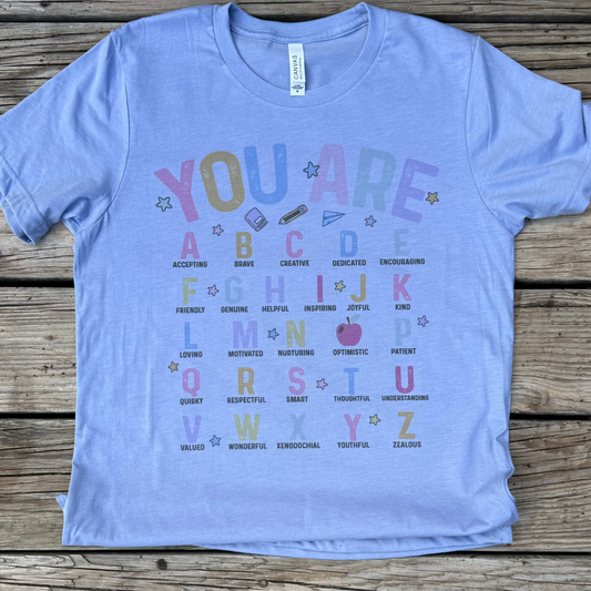 Printed on a Bella Canvas Heather Blue

Show your love for education with our "You Are ABCs" teacher t-shirt. Made with high-quality Bella Canvas fabric, this shirt is both comfortable and durable. And with its motivational and inspiring design, it's the perfect shirt for any educator to wear with pride. Join the movement and spread positivity in your classroom and beyond!