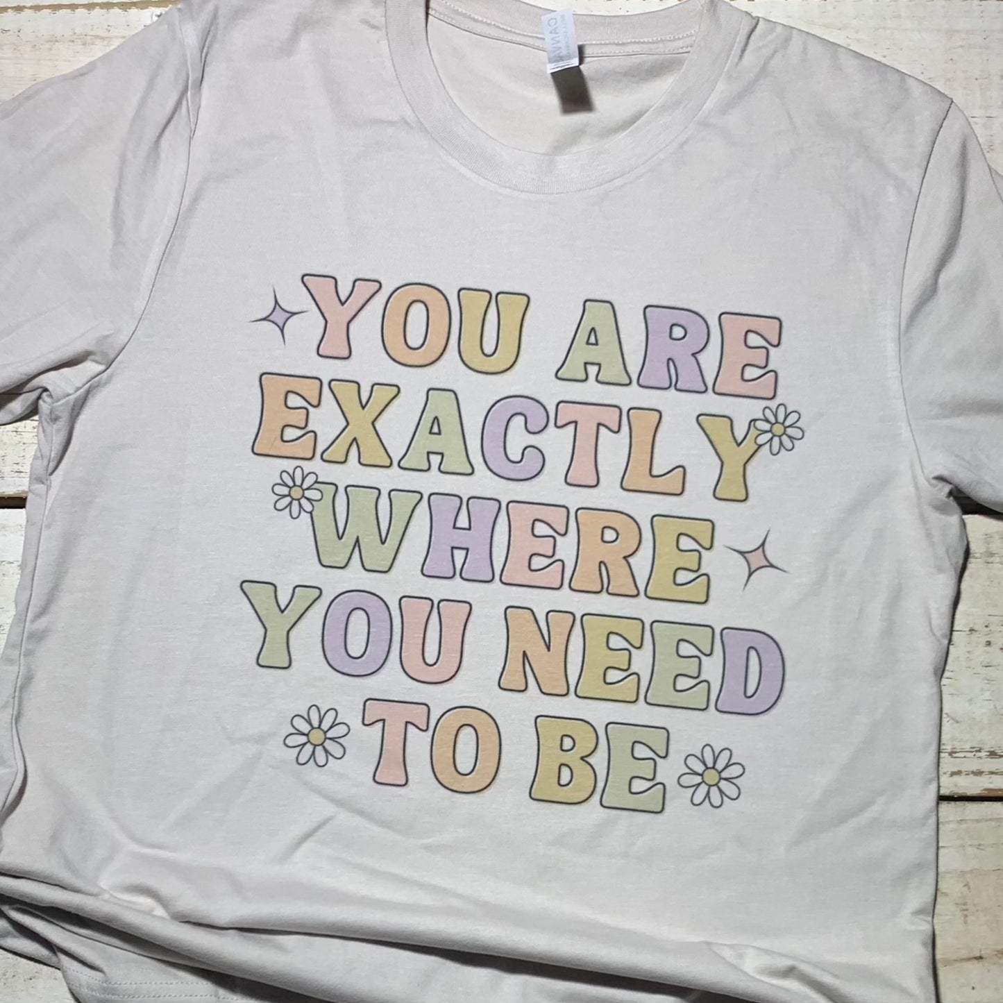 **Alt Text for "You Are Exactly Where You Need to Be" Teacher Shirt:**  A soft heathered Bella-Canvas shirt in Heather Dust color featuring the text "You Are Exactly Where You Need to Be" in a stylish font. The shirt is a comfortable and inspiring piece of clothing designed for teachers to wear in and out of the classroom. The message on the shirt reminds teachers of their important role in education and the impact they make on their students' lives.