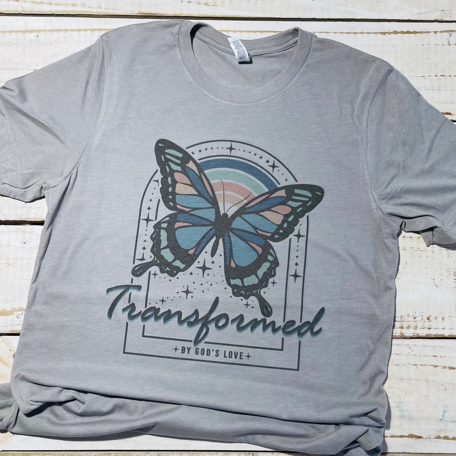 Alt text: "Transformed - Red Oak Faith Collection - Bella Canvas Heather Storm T-Shirt: A soft and durable shirt in red oak color featuring the Transformed design, combining comfort with a touch of inspiration for a unique expression of faith."