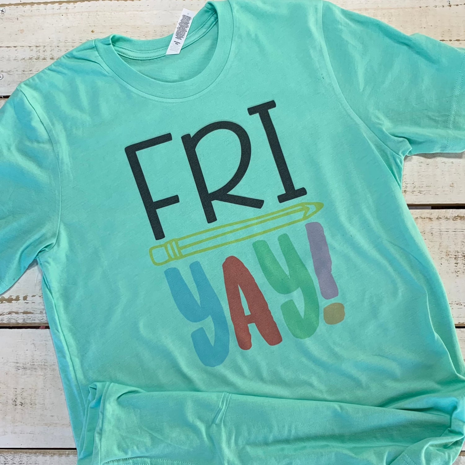 **Alt Text for "Fri-Yay Teacher Shirt" Image:**  "An image of a mint-colored teacher shirt with the words 'Fri-Yay Teacher Shirt' printed in playful, cheerful fonts. The design embodies the excitement of Fridays, making it a perfect addition to any teacher's wardrobe." Shirt for Teacher